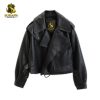 Studio flat lay product image of the black leather motorcycle jacket displaying its wide convertible collar, relaxed dropped shoulders, and the gold Surafh Industry woven neck label.