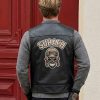Rear lifestyle perspective of a model showcasing a private label black leather biker vest featuring a large custom embroidered skull pilot patch and Surafh branding text.
