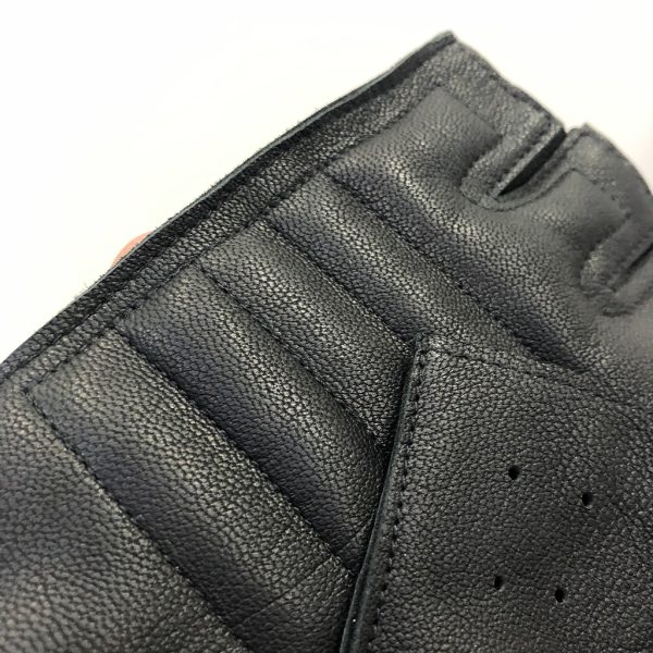 Detailed factory sample photo focusing on the secure double-stitching layout surrounding the finger bases and upper palm panel borders.