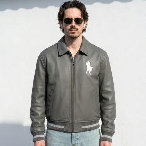 Front view of a sample custom men's slate gray leather bomber jacket displaying high-density white embroidery on the chest and custom striped ribbing.