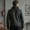 Back perspective of a private label black leather jacket showcasing a clean horizontal yoke seam, center back stitching, and buttoned waist adjustment tabs.