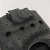 Macro close-up shot of the back casing on a wholesale leather tactical glove detailing the precise industrial multi-hole perforation and clean finger slot edge finishes.